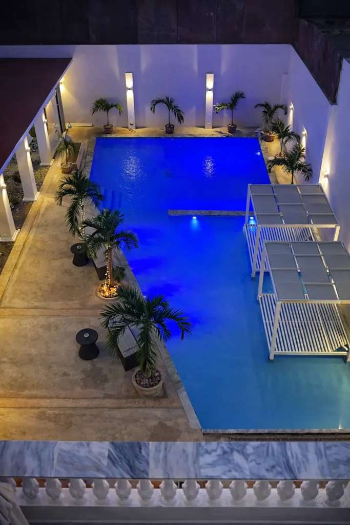 Elevated view down the Villa Pat pool at night
