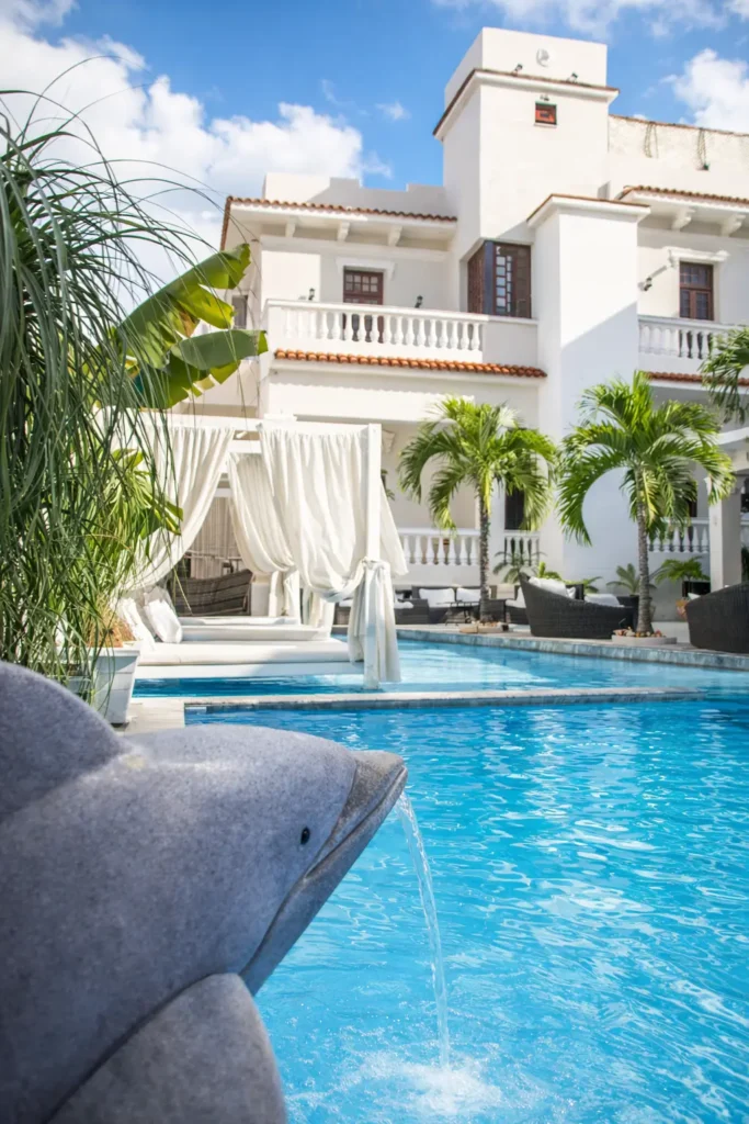 Daytime pool and curtained Balinese daybeds at Villa Pat
