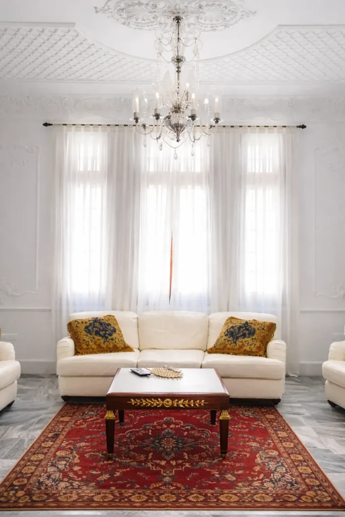 White sitting room with chandelier at Villa Pat