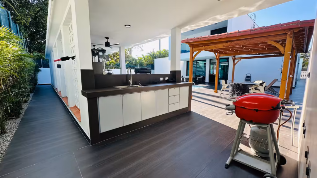 Outdoor kitchen and barbecue beside Villa Venezia pool