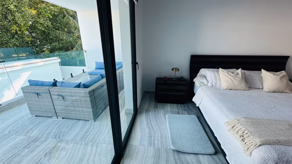 King bedroom opening to an upper terrace at Villa Venezia
