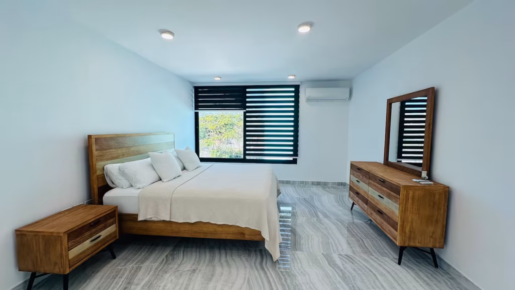 Spacious king bedroom with wood furniture at Villa Venezia