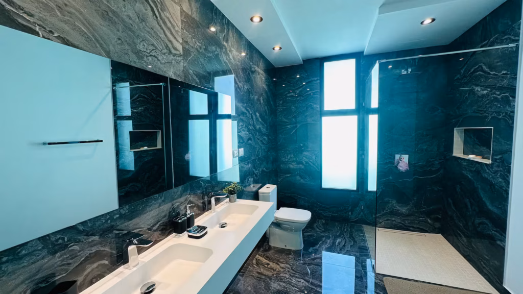 Dark marble bathroom with twin vanity at Villa Venezia