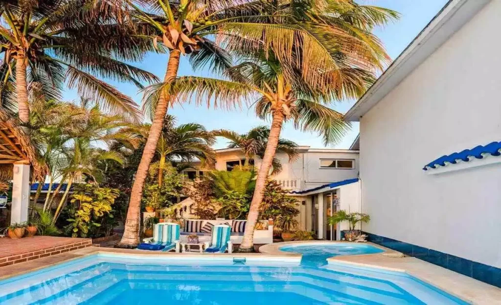 Villa Yan pool surrounded by palms and white walls