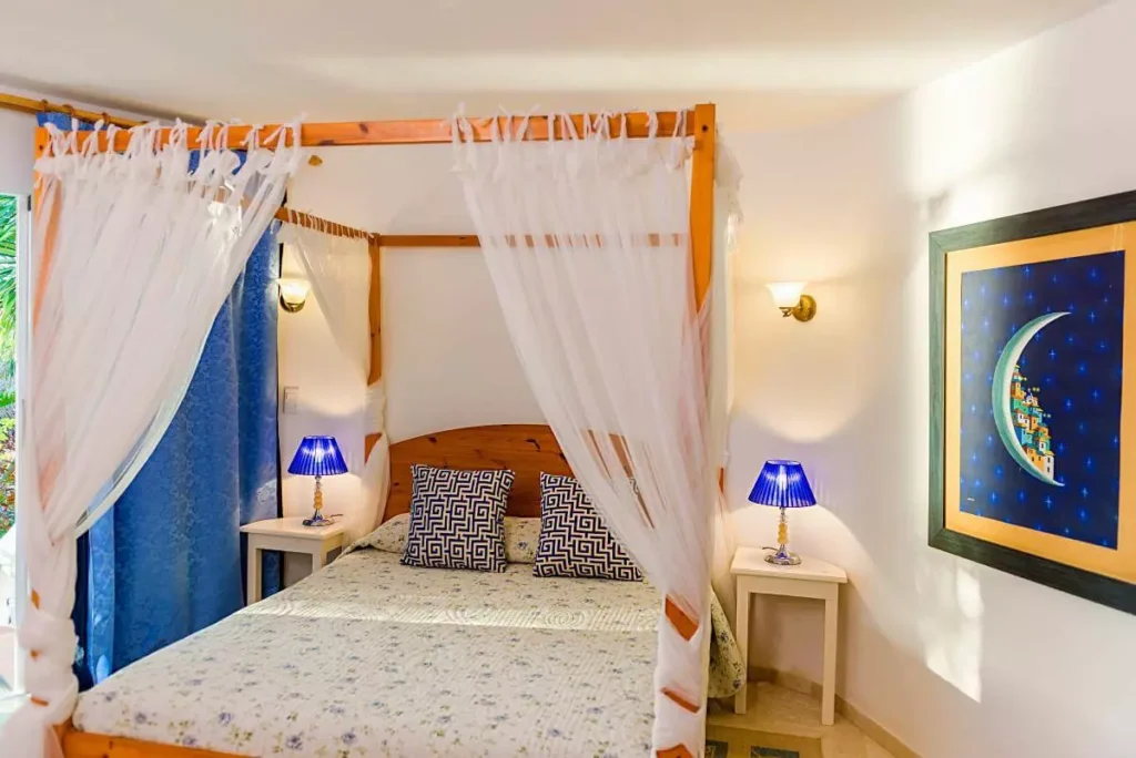 Canopy queen bedroom with artwork at Villa Yan