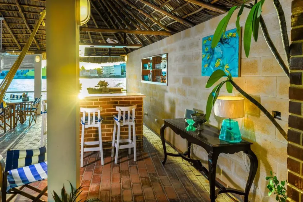 Stone bar and covered lounge beneath the Villa Yan open-air pavilion